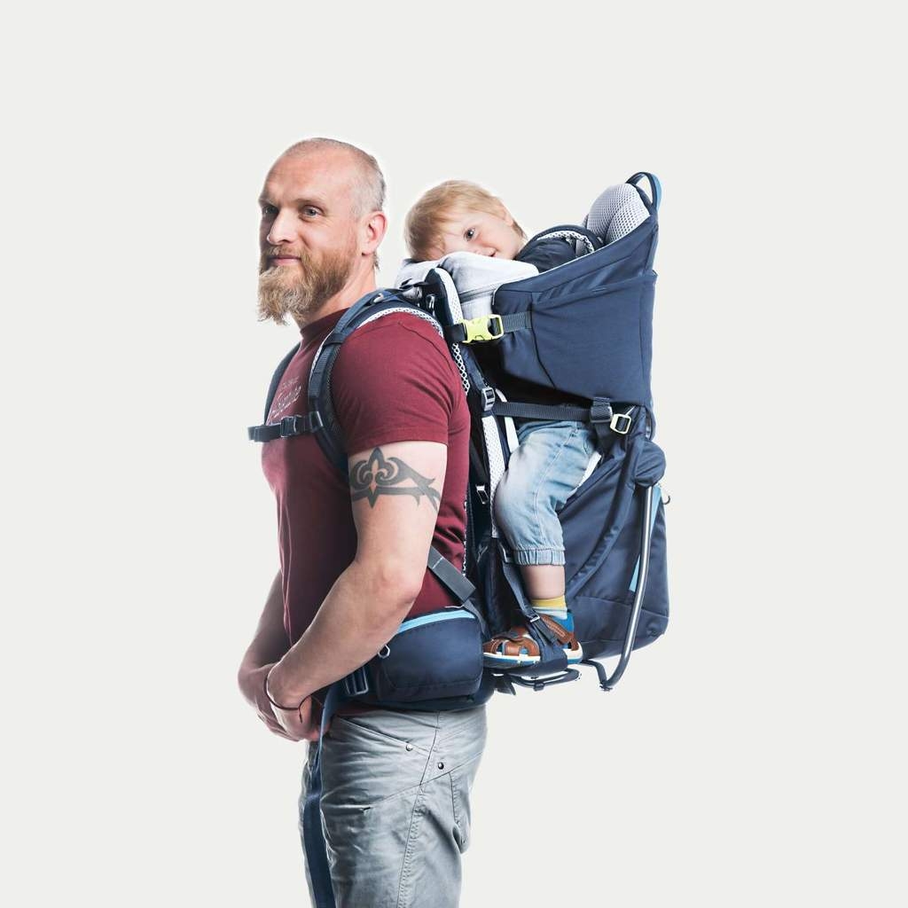 Man with a child in child-carrier backpack.