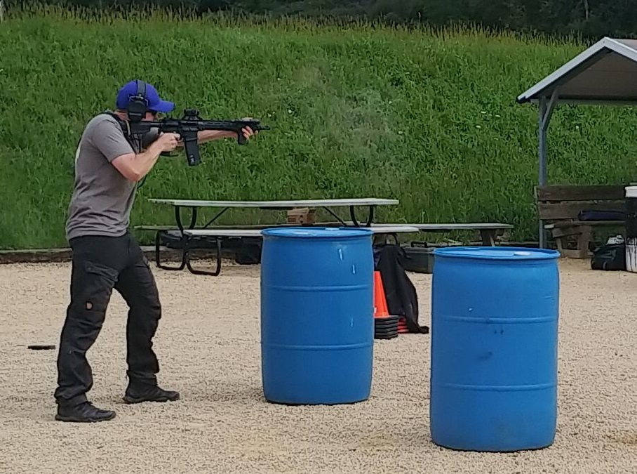 Standing offhand tactical shooting in Fjallraven trousers.