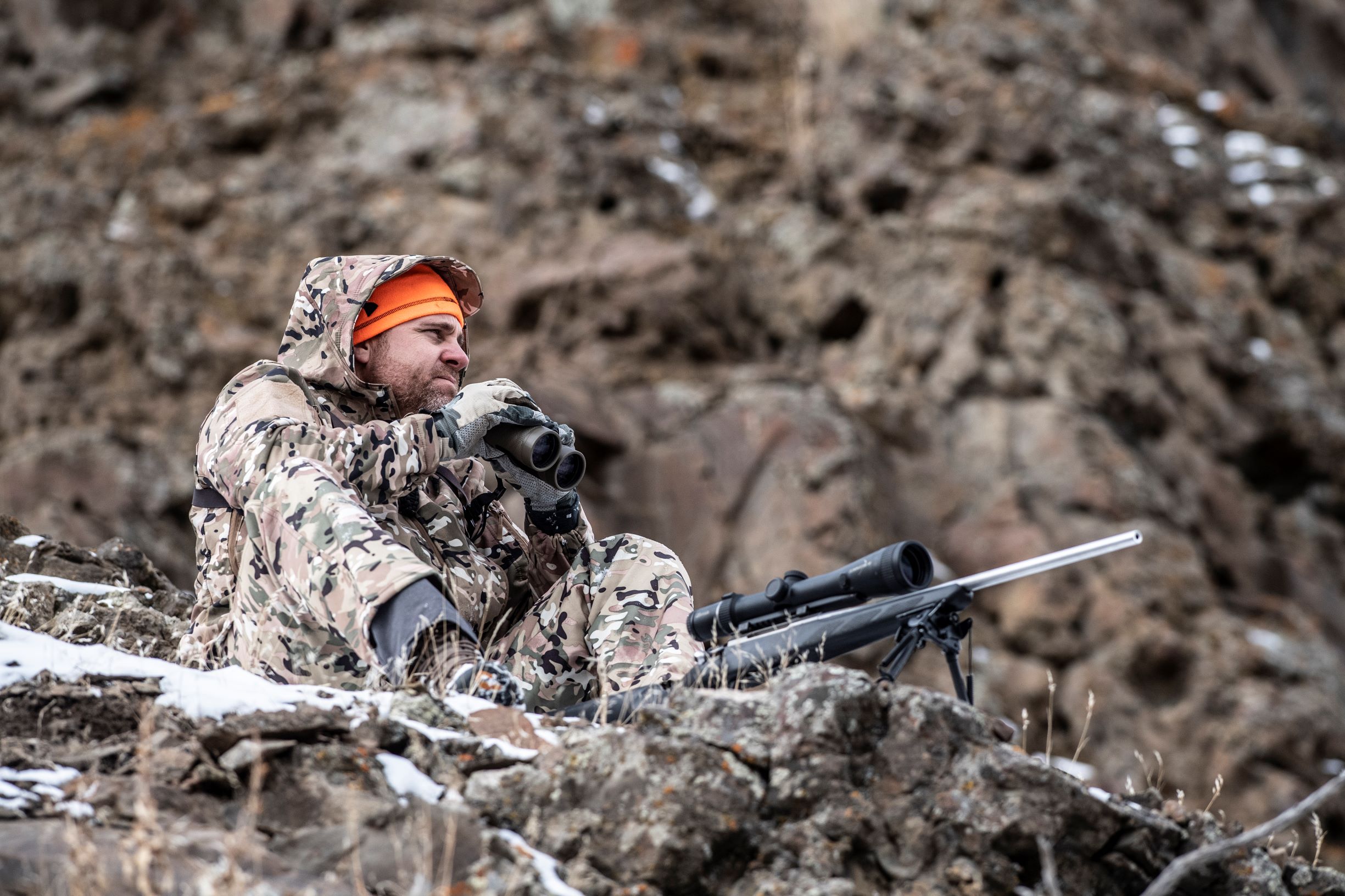hunter wearing camouflage and blaze orange