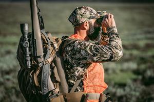 hunter using binoculars for observation