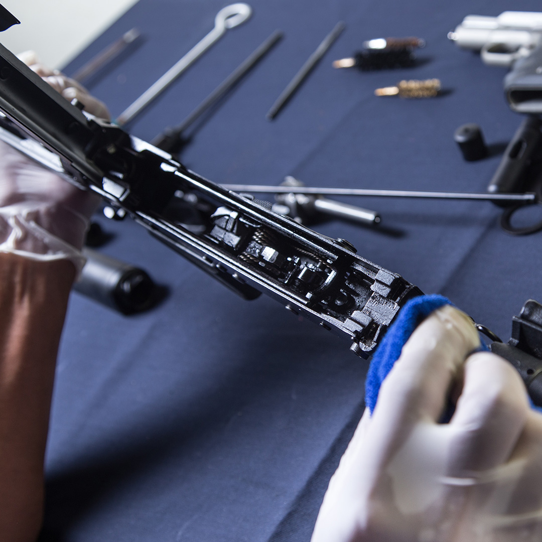 Disassembled rifle being cleaned.