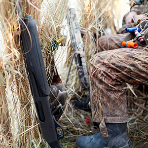 duck hunter wearing camo in hunting blind