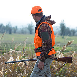 duck hunter wearing blaze orange safety vest